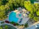 Aerial view of a sparkling community pool and lounge area surrounded by lush trees at 14861 W Ashland Ave, Goodyear, AZ 85395