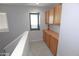 Upstairs landing features built-in storage cabinets and a window for natural light at 14861 W Ashland Ave, Goodyear, AZ 85395