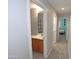 Upstairs hallway leading to a bathroom and bedroom with natural lighting at 14861 W Ashland Ave, Goodyear, AZ 85395