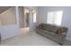 Bright living room with tile flooring, neutral walls, a comfortable couch, and a large window for natural light at 14861 W Ashland Ave, Goodyear, AZ 85395