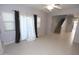 Spacious living room with modern tile flooring, neutral walls, ample natural light, and easy access to the staircase at 14861 W Ashland Ave, Goodyear, AZ 85395