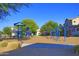 Community playground featuring colorful equipment and mature landscaping near houses at 14861 W Ashland Ave, Goodyear, AZ 85395