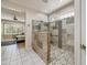 Beautiful main bathroom showcases a large walk-in shower with decorative tile, glass surround, and a stained glass window at 15532 W Prairie Dunes Dr, Surprise, AZ 85374
