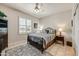 Comfortable bedroom with ceiling fan, large window, and tasteful decor, perfect for relaxation and rest at 15532 W Prairie Dunes Dr, Surprise, AZ 85374