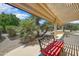 Comfortable covered patio with an inviting bench and shade, perfect for enjoying the outdoors at 15532 W Prairie Dunes Dr, Surprise, AZ 85374