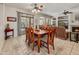 Inviting dining area adjacent to living room featuring a wooden table and seating for six at 15532 W Prairie Dunes Dr, Surprise, AZ 85374