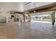 Open three-car garage showcasing ample space and convenience with an open garage door overlooking the front yard at 15532 W Prairie Dunes Dr, Surprise, AZ 85374