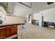 Large three-car garage, with built-in cabinets and workbench, offering space for vehicles, storage, and projects at 15532 W Prairie Dunes Dr, Surprise, AZ 85374