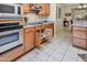 A lovely kitchen is showcased with sleek appliances, granite countertops, and wood cabinets featuring specialized storage solutions at 15532 W Prairie Dunes Dr, Surprise, AZ 85374