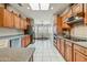 Well-appointed kitchen with abundant wood cabinetry, stainless steel appliances, and easy access to the dining area at 15532 W Prairie Dunes Dr, Surprise, AZ 85374
