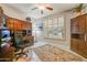 This home office provides ample storage and bright lighting with custom built-ins, desk space and plantation shutters at 15532 W Prairie Dunes Dr, Surprise, AZ 85374