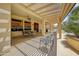 Charming covered patio with outdoor seating and space for grilling is ideal for entertaining at 15532 W Prairie Dunes Dr, Surprise, AZ 85374