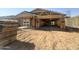 Exterior view of a new home under construction with wood framing and a garage at 15752 W Camden Ave, Waddell, AZ 85355