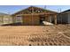 Exterior view of a new home under construction, highlighting wood framing and the structure at 15752 W Camden Ave, Waddell, AZ 85355