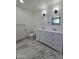 Stylish bathroom featuring a double sink vanity, modern fixtures, and marble-style flooring at 1627 W Pueblo Ave, Mesa, AZ 85202