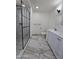 Renovated bathroom with glass-enclosed shower, dual vanity, and modern finishes at 1627 W Pueblo Ave, Mesa, AZ 85202