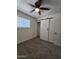 Bright bedroom featuring neutral carpet, a ceiling fan and modern sliding door closet at 1627 W Pueblo Ave, Mesa, AZ 85202