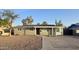 Charming single-story home featuring desert landscaping, neutral paint, and a covered front porch at 1627 W Pueblo Ave, Mesa, AZ 85202