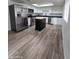 Bright kitchen boasts stainless steel appliances, a convenient island, and modern finishes at 1627 W Pueblo Ave, Mesa, AZ 85202
