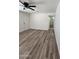 Open living area with new plank flooring, white doors, and a ceiling fan, perfect for gatherings at 1627 W Pueblo Ave, Mesa, AZ 85202