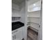 Walk-in pantry with bright shelves offers organized storage solutions at 1627 W Pueblo Ave, Mesa, AZ 85202
