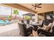 Enjoy outdoor living on the patio, complete with a barbecue, bar, fountain, and palm trees at 16781 W Northampton Rd, Surprise, AZ 85374