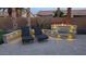 Backyard patio with fire pit, lounge chairs and warm lighting, perfect for outdoor relaxation at 16781 W Northampton Rd, Surprise, AZ 85374