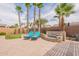 Landscaped backyard with a putting green, lounge chairs and beautiful stone waterfall features at 16781 W Northampton Rd, Surprise, AZ 85374