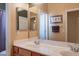 Bathroom with double sinks and mirrors, towel rack and neutral walls at 16781 W Northampton Rd, Surprise, AZ 85374