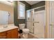 Bathroom with glass door shower, window with shutters and neutral walls at 16781 W Northampton Rd, Surprise, AZ 85374