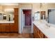 Bathroom with double sink vanity and view into walk-in closet at 16781 W Northampton Rd, Surprise, AZ 85374