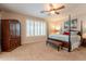 Spacious bedroom featuring 4 post bed, ceiling fan, and neutral carpet and walls at 16781 W Northampton Rd, Surprise, AZ 85374