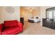 Bedroom featuring sitting area, ceiling fan, and neutral carpet and walls at 16781 W Northampton Rd, Surprise, AZ 85374