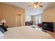 Bedroom featuring seating area, ceiling fan, and neutral carpet and walls at 16781 W Northampton Rd, Surprise, AZ 85374