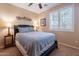 Bedroom with ceiling fan, window with shutters, and neutral carpet and walls at 16781 W Northampton Rd, Surprise, AZ 85374