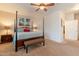 Primary bedroom featuring a four-poster bed, neutral tones, and ample natural light at 16781 W Northampton Rd, Surprise, AZ 85374