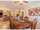 Elegant dining room boasts a wooden table, decorative centerpiece, and seamless access to the open-concept living area at 16781 W Northampton Rd, Surprise, AZ 85374