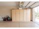 Well-organized garage with storage cabinets and an open door to the outside at 16781 W Northampton Rd, Surprise, AZ 85374