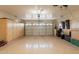 Clean garage with epoxy floor and ample storage cabinets, allowing for a clutter-free space at 16781 W Northampton Rd, Surprise, AZ 85374