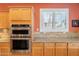 Modern stainless steel double ovens and granite countertops highlight this kitchen at 16781 W Northampton Rd, Surprise, AZ 85374