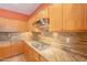 This well-appointed kitchen features granite countertops and a gas cooktop at 16781 W Northampton Rd, Surprise, AZ 85374