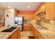 Well-equipped kitchen with stainless steel refrigerator, granite counters, and ample cabinet space at 16781 W Northampton Rd, Surprise, AZ 85374