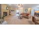 Open living room with a stone fireplace, neutral tones, and comfortable leather seating at 16781 W Northampton Rd, Surprise, AZ 85374