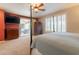 Bedroom with sliding glass doors to patio, ceiling fan and neutral carpet and walls at 16781 W Northampton Rd, Surprise, AZ 85374