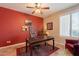 Inviting office space features a rich color palette, a comfortable leather chair, and a meticulously designed workspace at 16781 W Northampton Rd, Surprise, AZ 85374