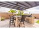Outdoor bar and barbecue area under a shaded pergola for year-round entertaining at 16781 W Northampton Rd, Surprise, AZ 85374