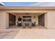 Inviting covered patio offers comfortable seating and a ceiling fan for relaxed outdoor living at 16781 W Northampton Rd, Surprise, AZ 85374