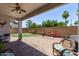 Inviting backyard with brick patio, covered area with ceiling fan, and putting green at 16803 N 49Th Way, Scottsdale, AZ 85254