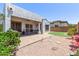 Exterior view of the home showcasing the putting green and covered patio at 16803 N 49Th Way, Scottsdale, AZ 85254