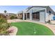 This backyard features a putting green, covered patio, and desert landscaping at 16803 N 49Th Way, Scottsdale, AZ 85254